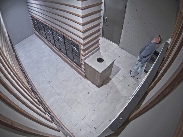 The male continues to look around the mail room suspiciously as he exits. The male continues to look around the mail room suspiciously as he exits.