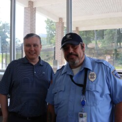 BOS Security President Nat Carmack presents appreciation token to Officer Enmon Goad President Nat Carmack and Officer Enmon Goad