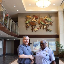 BOS Security President Nat Carmack presents token of appreciation to Officer Inez Brightwell President Nat Carmack and Officer Inez Brightwell