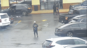 The suspect is handcuffed by police and is escorted into their patrol vehicle. The suspect is handcuffed by police and is escorted into their patrol vehicle.