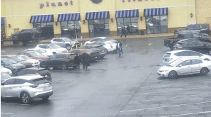 A tow truck drives away with the suspect's vehicle loaded on the bed of the truck. A tow truck drives away with the suspect's vehicle loaded on the bed of the truck.