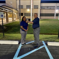 Site Supervisor Carl Howard presents token of appreciation to Officer Alecia Ewing Officer Alecia Ewing and Site Supervisor Carl Howard