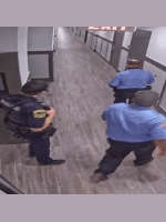 Two BOS Security Officers lead a local police officer to the injured male's apartment.