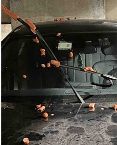 Vandalism to a car in a parking deck with hot dogs