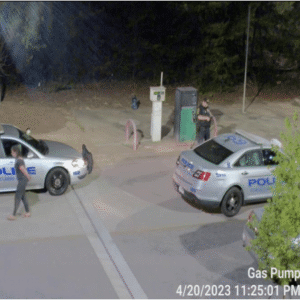 The female suspect is arrested and placed in a police vehicle. The female suspect is arrested and placed in a police vehicle.