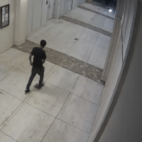 An unknown man enters the private parking deck of a student apartment complex.