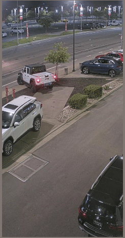 The white Jeep truck is seen being driven off of the lot and fleeing the area.