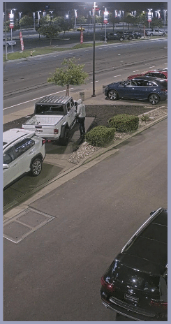 The first suspect approaches a white Jeep truck.