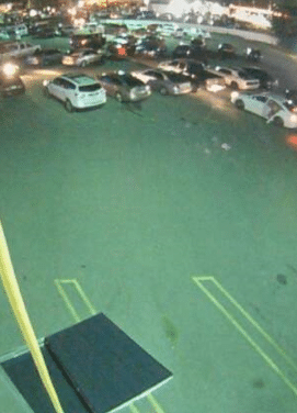 A crowd of vehicles begins to gather in the vacant parking lot.